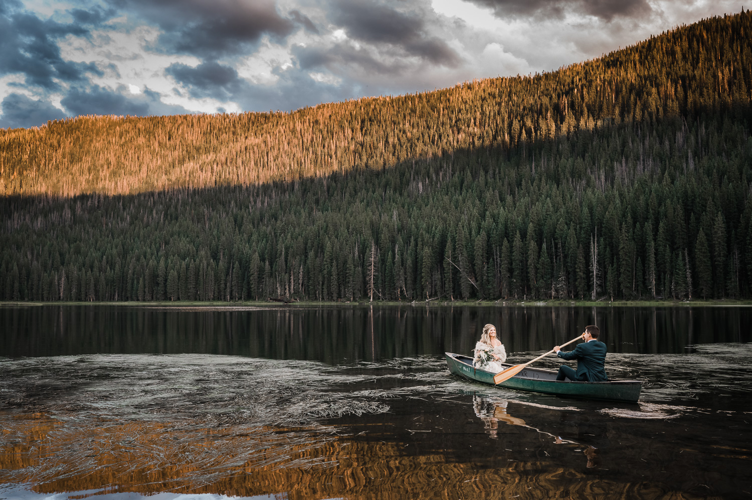 Bride and Groom in canoe at Sunset on Piney Lake